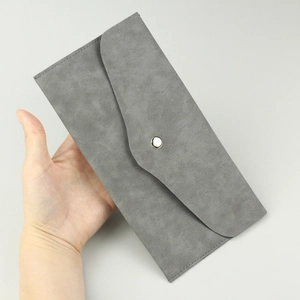 Detailed view of grey suede PU envelope makeup brush bag with metallic snap button closure