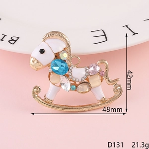 Golden rocking horse brooch with colorful crystals and rhinestones, size 48mm x 42mm