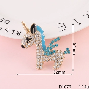 Macro shot of gold-plated unicorn brooch with blue and white rhinestones detail