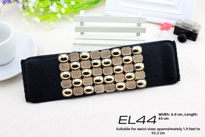 Detail of 6cm black elastic waist belt with gold metallic studs and pebble leather