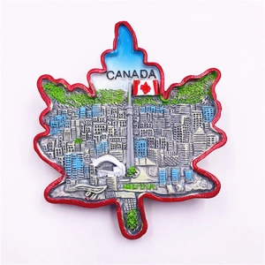 Detail of resin Canada souvenir fridge magnet with maple leaf shape and CN Tower relief
