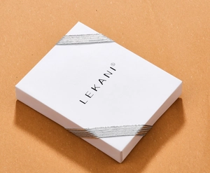 White rectangular jewelry gift box featuring a silver ribbon and LEKANI logo detail