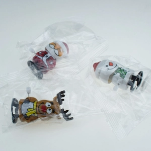 Packaged wind-up Santa, Snowman, and Reindeer Christmas toys in clear plastic bags