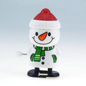 Detail of wind-up snowman toy with red hat and green scarf for Christmas gift