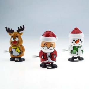 Three cute wind-up Christmas toys featuring Santa, Reindeer and Snowman on white background