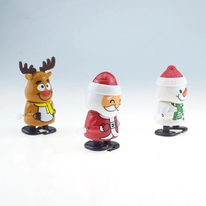 Close-up of colorful plastic Christmas wind-up toys featuring Santa, snowman and reindeer