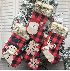 Detail of four buffalo plaid Christmas stockings with 3D Santa and reindeer appliques