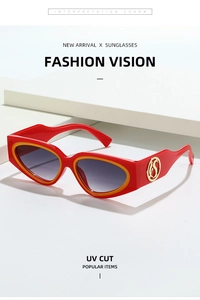 Detail of red cat-eye sunglasses with dual-color resin frame and golden logo