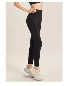 Close-up side view of black high-waisted yoga pants showing lifting effect and fabric texture