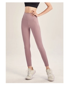 Detailed side view of high-waisted smoky pink yoga pants with a wide shaping waistband