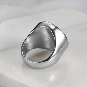 Close-up of silver punk ring showing polished surface and brushed inner band details