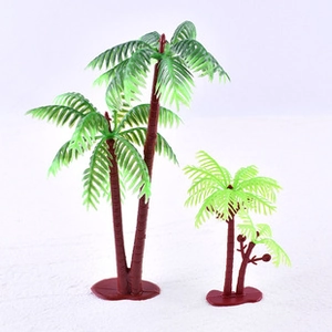 Detailed view of plastic palm tree cake toppers with brown trunks and green fronds