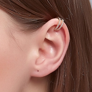 Close-up of elegant rose gold double-layered rhinestone ear cuff on a model's ear