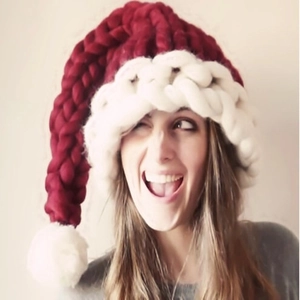 Handmade red and white chunky knit Christmas hat with long tail and oversized pompom detail