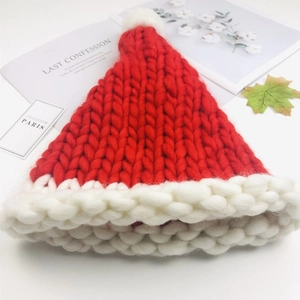 Handmade red knit Christmas hat with white pom-pom and thick Iceland wool texture