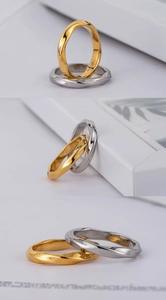 Close-up of gold and silver Mobius rings with twisted lines and high polished finish