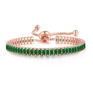 Detailed macro of emerald green square zircons and rose gold bolo bracelet clasp