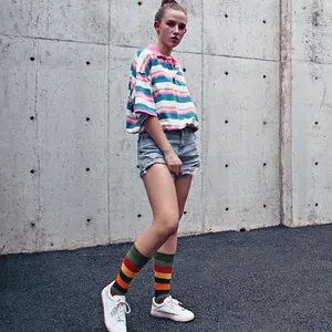 Streetwear style colorful striped polo shirt with matching crew socks and denim shorts