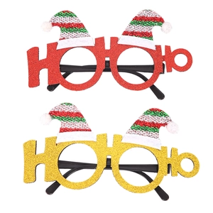 Detail of red and gold glitter Christmas eyewear frames with striped Santa hat decor