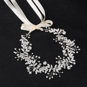 Handmade bridal sash with silver pearls and rhinestones on a black background