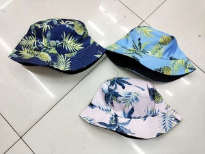 Three-pack tropical pineapple print bucket hats in navy, sky blue, and pink canvas