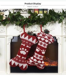 Detail of dog bone shaped Christmas stockings with knitted paw and snowflake patterns