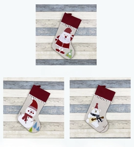 Detailed view of non-woven fabric Christmas stockings with cartoon Santa and snowman embroidery