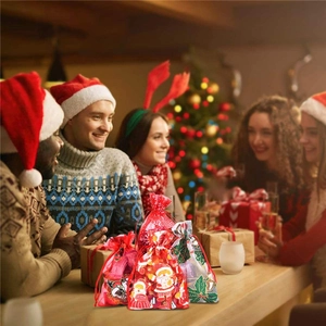 Red Christmas drawstring organza gift bags with festive Santa and snowflake patterns