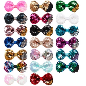 Detailed grid view of assorted colorful sequin hair bows with velvet texture and soft pom-poms