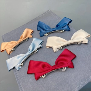 Set of five colorful satin ribbon bow hair clips with silver metal fasteners for women