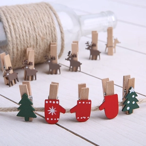 Christmas wooden clips set with gloves and tree shapes hanging on jute rope