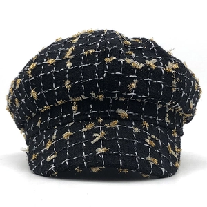 Classic black tweed newsboy cap with gold tinsel and white grid stitching on white background