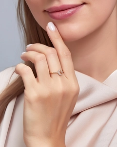 Detailed view of moon-shaped ring with pavé crystals on elegant silk background