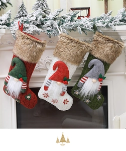 Three knitted Christmas stockings with 3D gnome dolls hanging on a festive fireplace