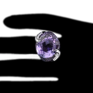 Elegant silver ring featuring a large oval purple zircon and sparkling side stones