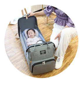 Detail of expandable baby diaper bag transforming into a portable travel bassinet crib