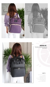 Detail view of large capacity diaper backpacks in purple and grey with zipper pockets