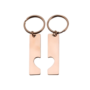 Detail of interlocking heart cutout on rose gold stainless steel rectangle keychains