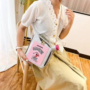 Silver sequin oil can shaped crossbody bag with pink patches and chain strap