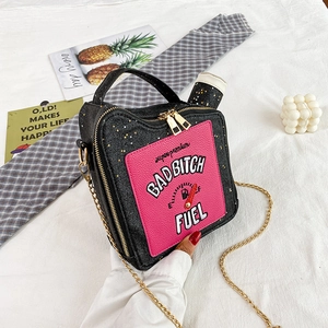 Detail of creative oil can handbag featuring sequin glitter and bold letter embroidery