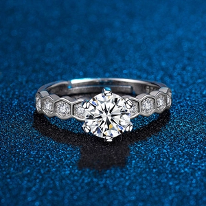 Macro detail of six-prong S925 silver moissanite ring with honeycomb pave setting