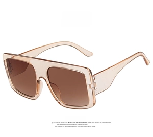 Detail view of champagne square sunglasses with gradient brown lenses and transparent frame