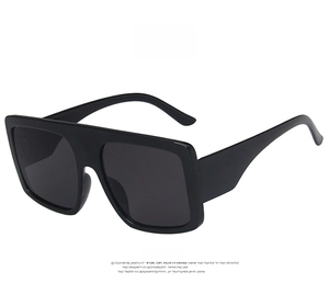 Front detail of oversized square sunglasses with black frame and solid grey lenses