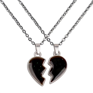 Macro shot of two stainless steel heart necklaces with color-changing glitter inlay detail