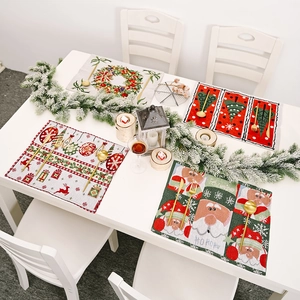 Set of four knitted Christmas placemats with festive holiday patterns and vivid colors