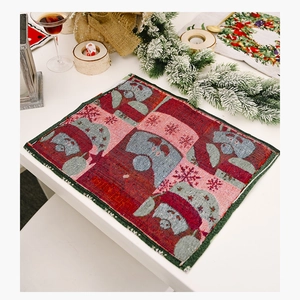Close-up of festive knitted Christmas placemat featuring gnome patterns and textile texture