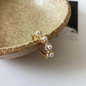 Detailed macro view of S925 silver gold-plated ring with pearls and marquise zircons