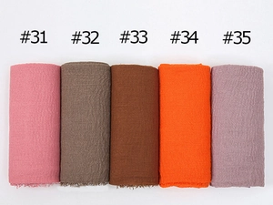 Detail of crinkled cotton scarves with frayed edges in multiple colors #31-#35