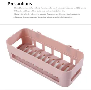 Installation guide for pink wall-mounted adhesive storage basket showing drain holes