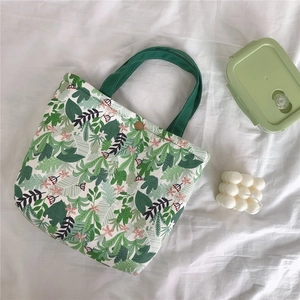 Close-up of vintage floral canvas lunch bag with leaf patterns and metal snap button